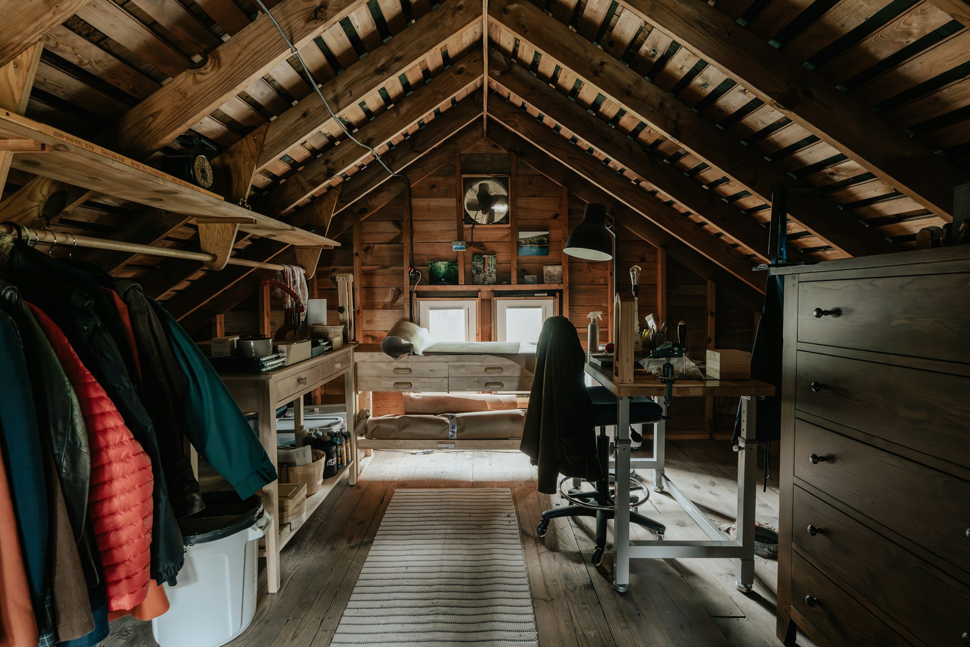 Finished attic with desk, drawers, and fan clearly visible