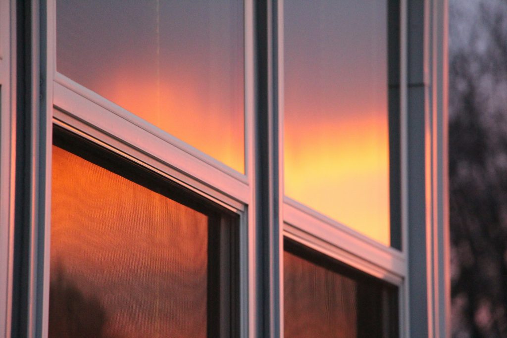 Double hung windows reflecting the sunset