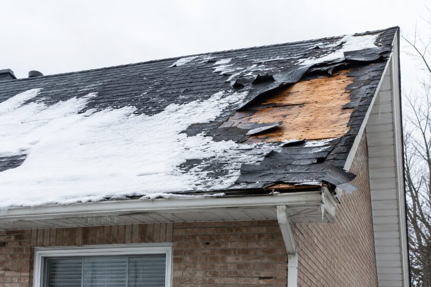 roof showing severe damage after winter storm